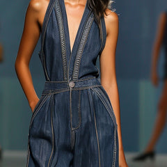 Dark blue denim women's sleeveless V-neck jumpsuit with wide-leg pants, styled by Christine Brewer, shown on a model.