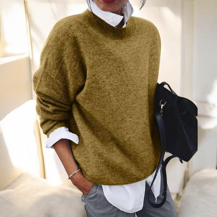 Beige knit sweater for women by Christine Brewer, featuring a cozy, textured design with a high neckline and long sleeves.