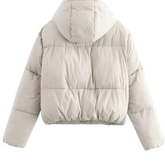 Kira hooded puffer jacket for women by Christine Brewer featuring a quilted design and a cozy hood for warmth.