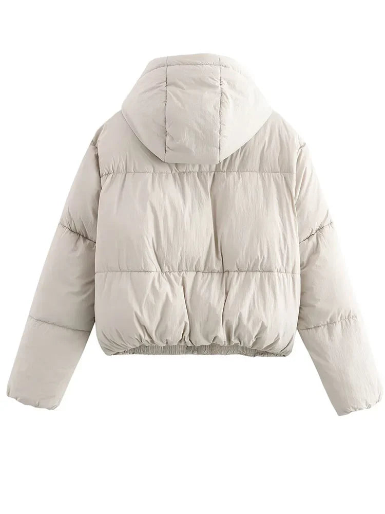 Kira hooded puffer jacket for women by Christine Brewer featuring a quilted design and a cozy hood for warmth.