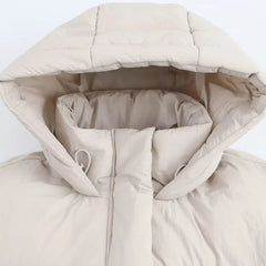 Kira hooded puffer jacket for women by Christine Brewer, featuring a quilted design and cozy hood for cold weather.