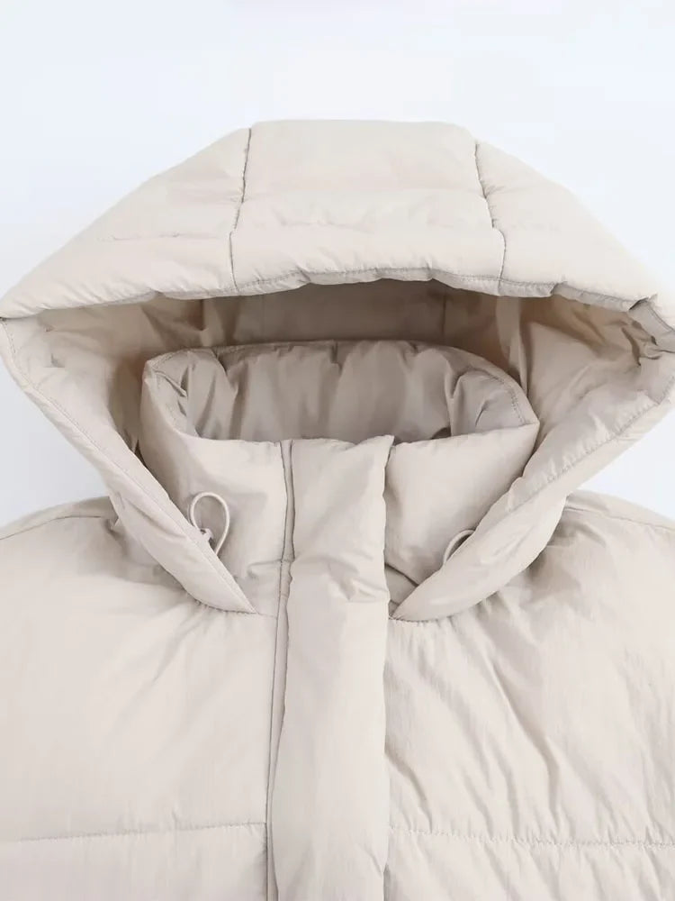 Kira hooded puffer jacket for women by Christine Brewer, featuring a quilted design and cozy hood for cold weather.