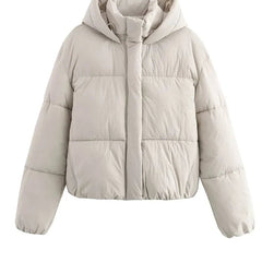 White Christine Brewer Grace hooded puffer jacket for women, showcasing the quilted design and cozy hood detail.