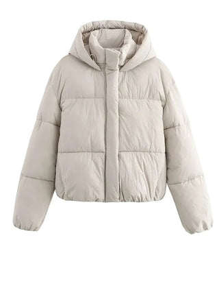 White Christine Brewer Grace hooded puffer jacket for women, showcasing the quilted design and cozy hood detail.