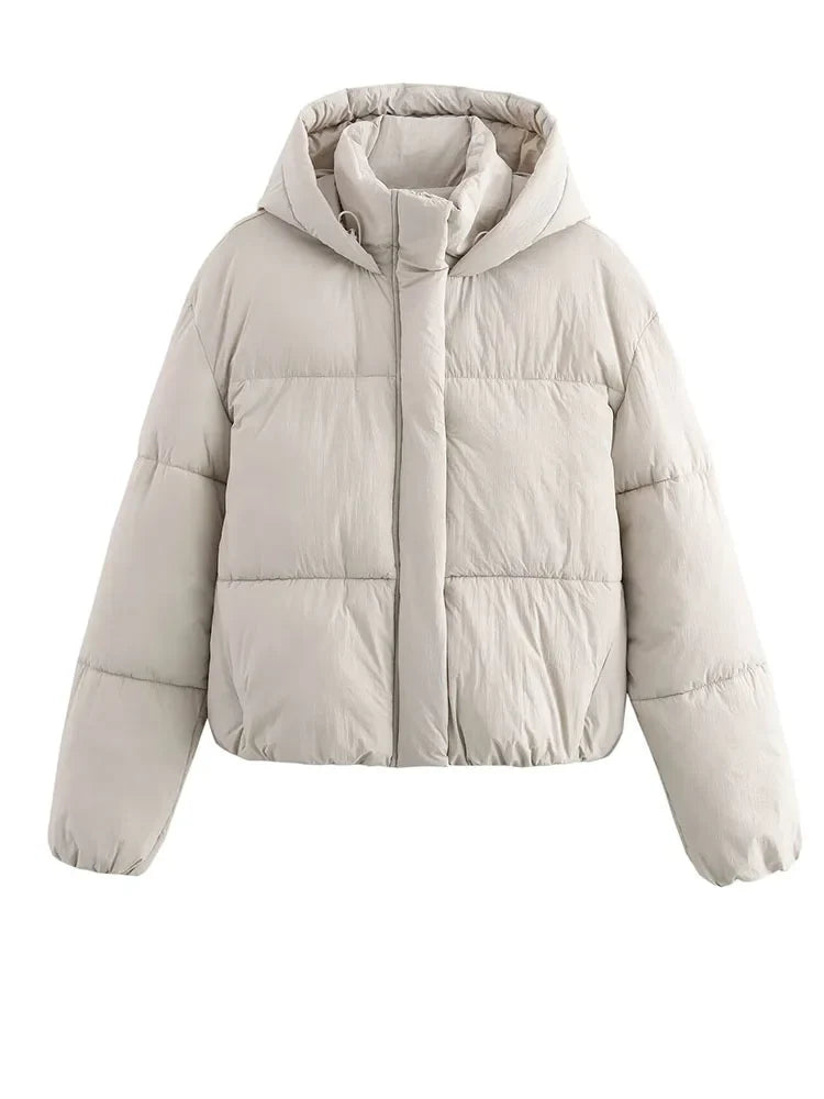 White Christine Brewer Grace hooded puffer jacket for women, showcasing the quilted design and cozy hood detail.
