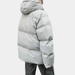 Lightly quilted Sienna long hooded puffer jacket for women by Christine Brewer, featuring a warm, padded design and hood.