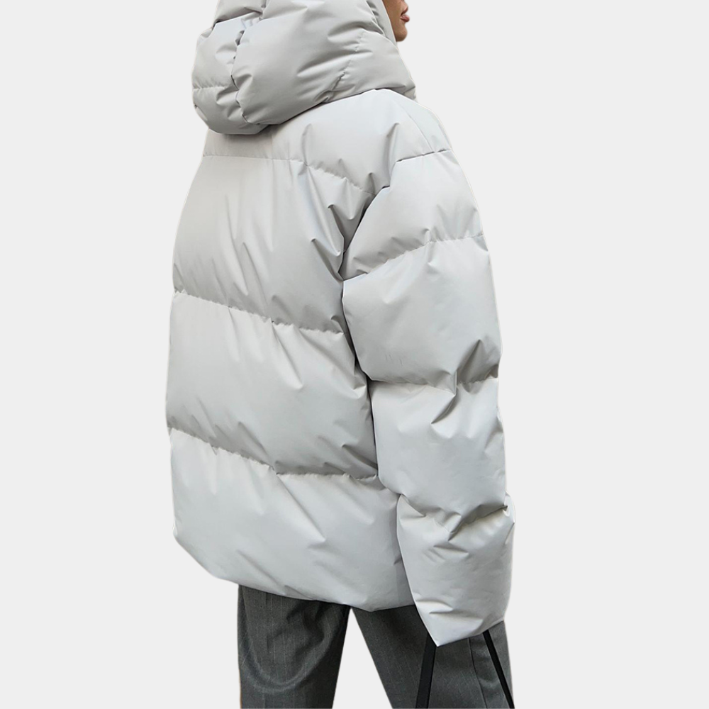 Lightly quilted Sienna long hooded puffer jacket for women by Christine Brewer, featuring a warm, padded design and hood.