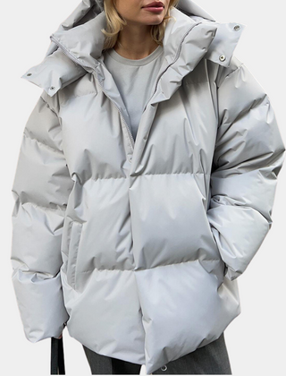 Lightly quilted Sienna long hooded puffer jacket for women by Christine Brewer, featuring a cozy hood and warm insulation.