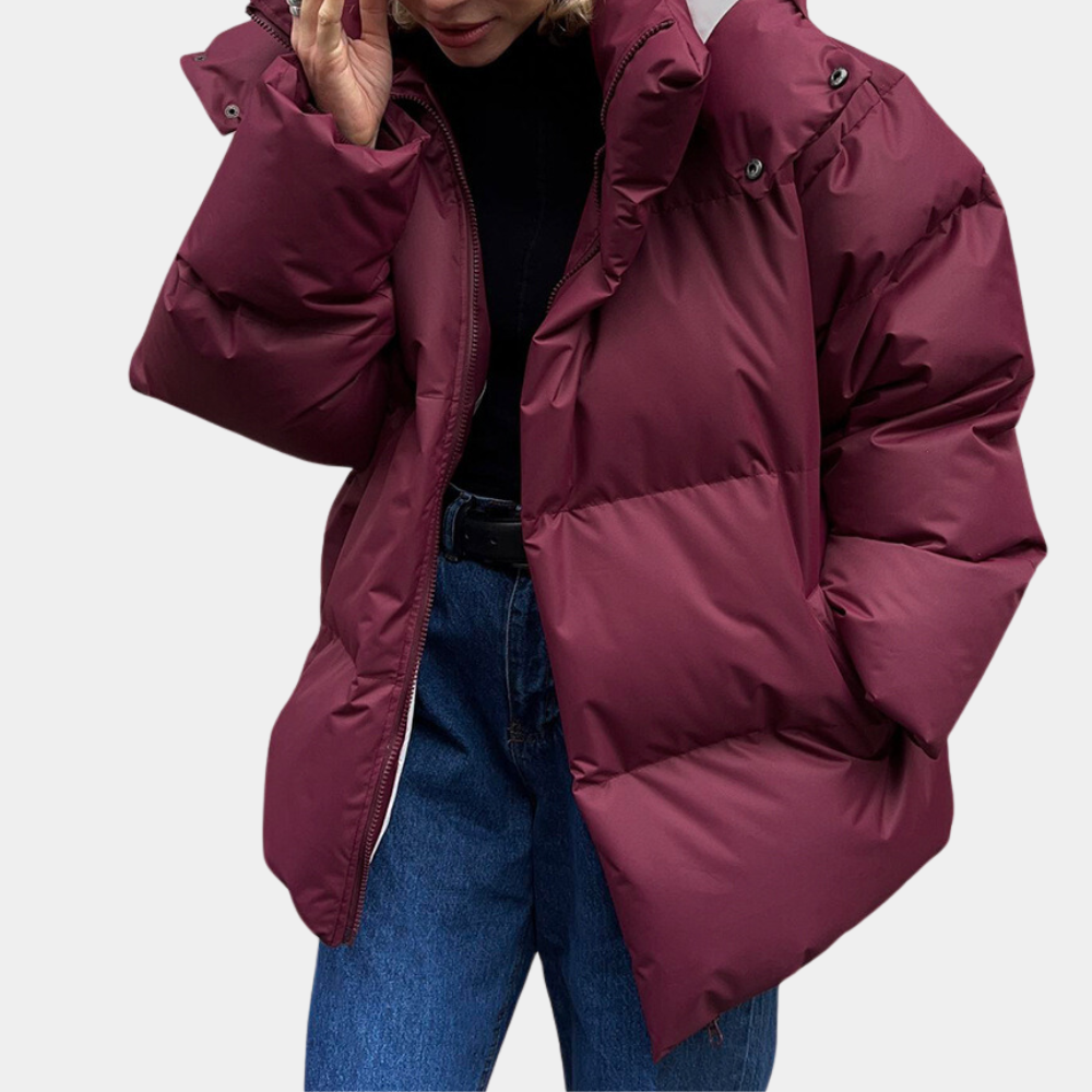 Lightly quilted Sienna long hooded puffer jacket for women by Christine Brewer, shown in a stylish, cozy design.