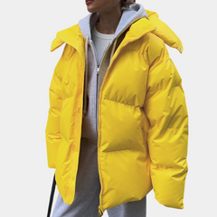 Lightly quilted Sienna long hooded puffer jacket for women by Christine Brewer, featuring a cozy hood and stylish design.