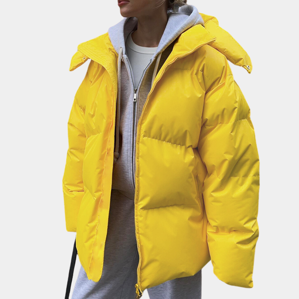 Lightly quilted Sienna long hooded puffer jacket for women by Christine Brewer, featuring a cozy hood and stylish design.