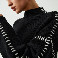 Black ribbed wool mock neck oversized sweater with whipstitch details, designed for autumn wear by Christine Brewer.