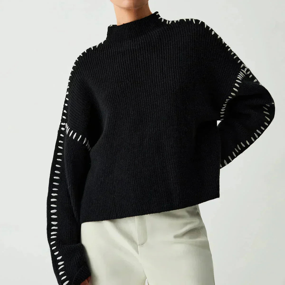 Black ribbed wool mock neck sweater by Christine Brewer, oversized and tailored, perfect for autumn wear.