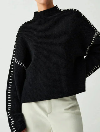 Black ribbed wool oversized sweater for women by Christine Brewer featuring a mock neck and whipstitch detailing.