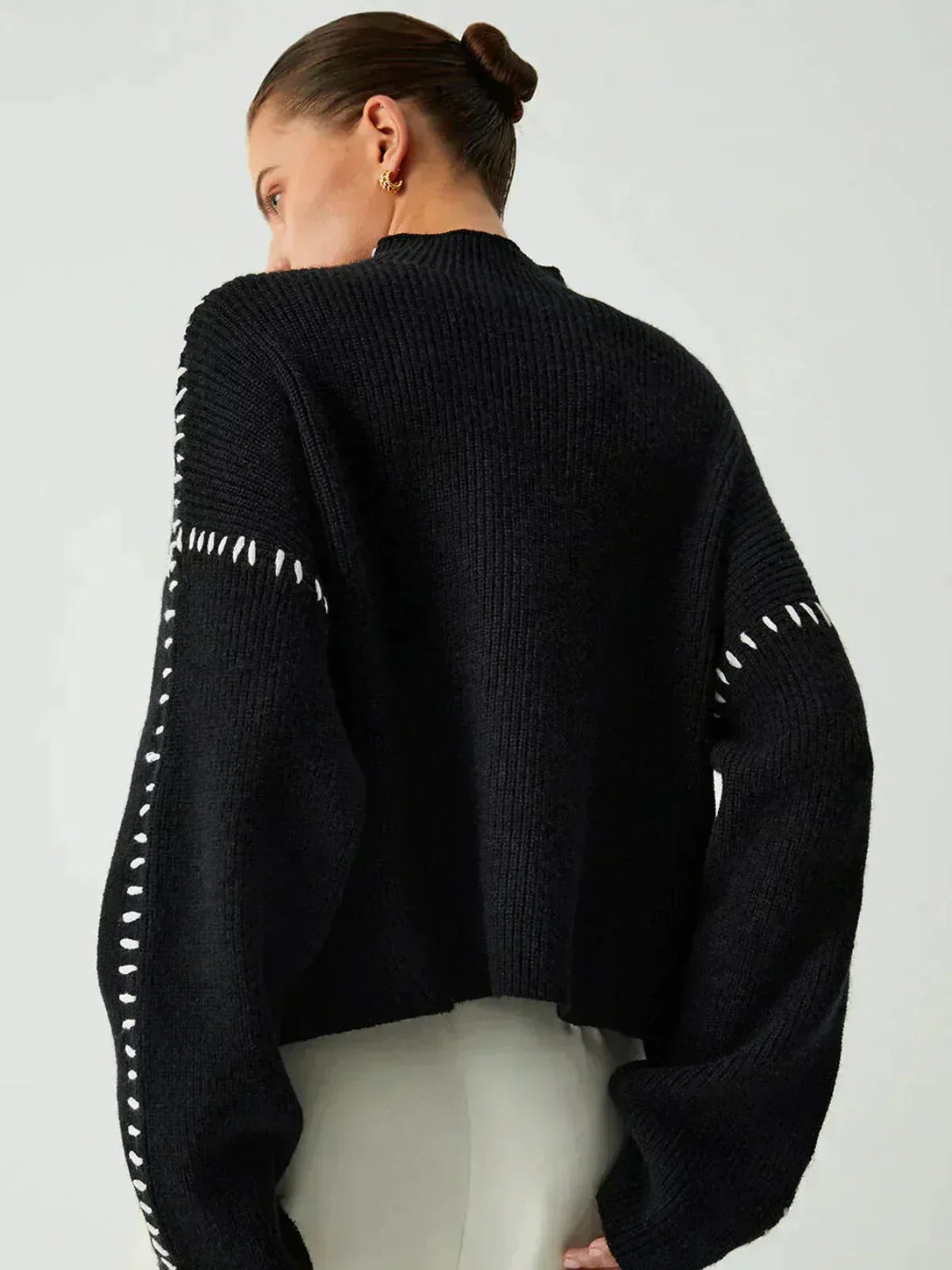 Black oversized ribbed wool mock neck sweater for women by Christine Brewer, perfect for autumn, featuring whipstitch details.
