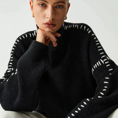 Black ribbed wool mock neck sweater by Christine Brewer, featuring whipstitch details, styled as a versatile oversized autumn sweater.