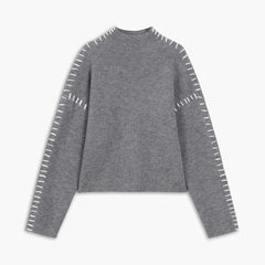 Light gray ribbed wool mock neck sweater by Christine Brewer, featuring whipstitch details and an oversized, versatile autumn style.