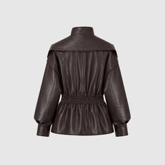 Manon wears a sleek, faux leather jacket with a cinched waist from Christine Brewer's Lucy collection, stylish and modern for women.