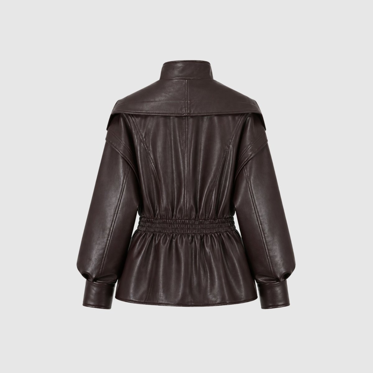 Manon wears a sleek, faux leather jacket with a cinched waist from Christine Brewer's Lucy collection, stylish and modern for women.