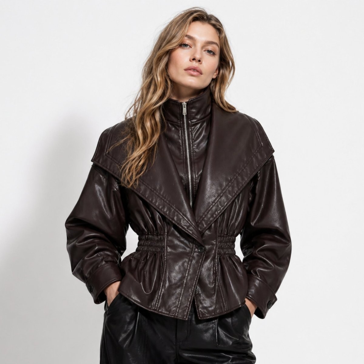 Dark brown faux leather jacket for women by Christine Brewer, featuring a sleek, cinched waist design.