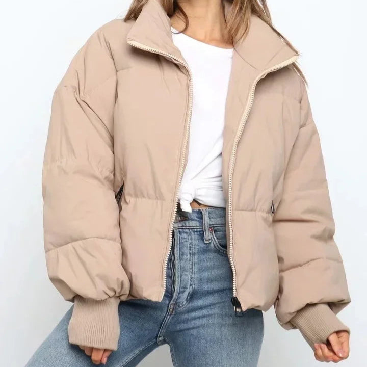 Beige Emily stand collar puffer jacket for women by Christine Brewer, featuring a cozy, stylish winter jacket with a stand collar.