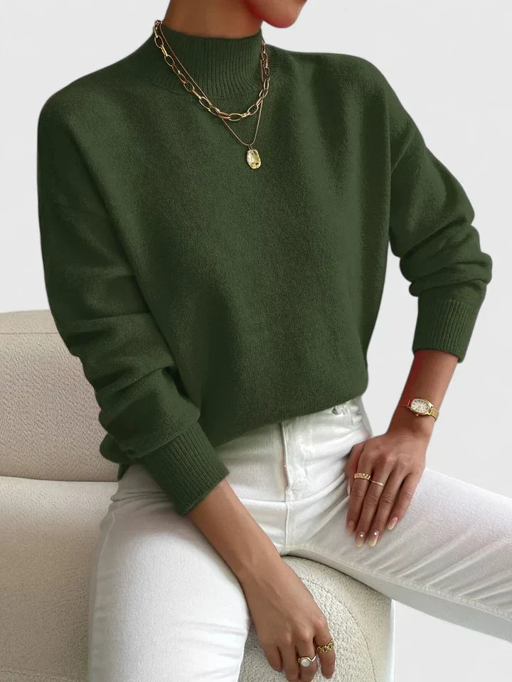 Elegant Maria model wearing a comfortable beige turtleneck sweater for women by Christine Brewer, showcasing a cozy, stylish knit design.
