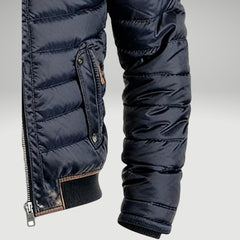 Men's quilted puffer jacket by Christine Brewer featuring a padded design and stand collar, suitable for winter wear.