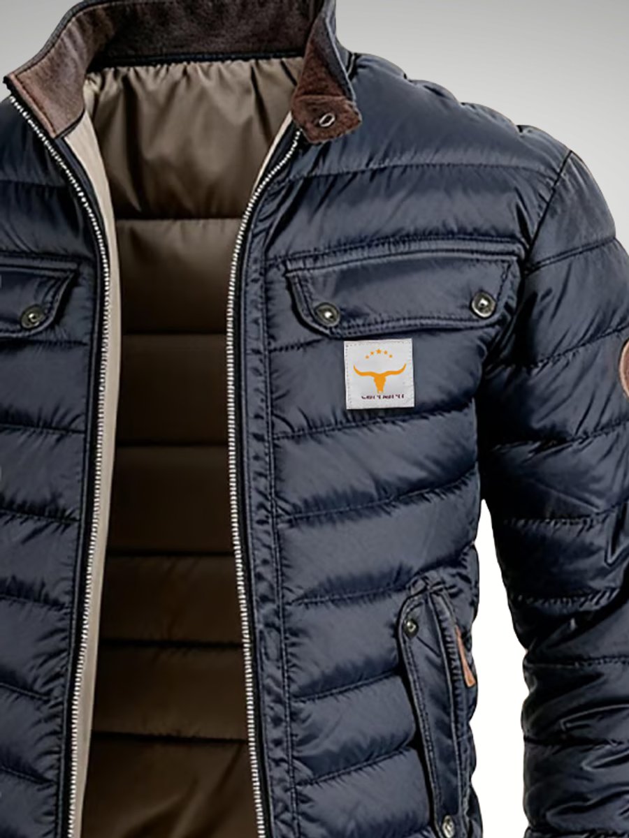 Men's quilted puffer jacket with stand collar, padded winter coat by Christine Brewer, shown in navy blue with zip closure and side pockets.