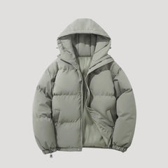Green Evelyn hooded puffer jacket for women by Christine Brewer, insulated with a cozy hood and quilted design.