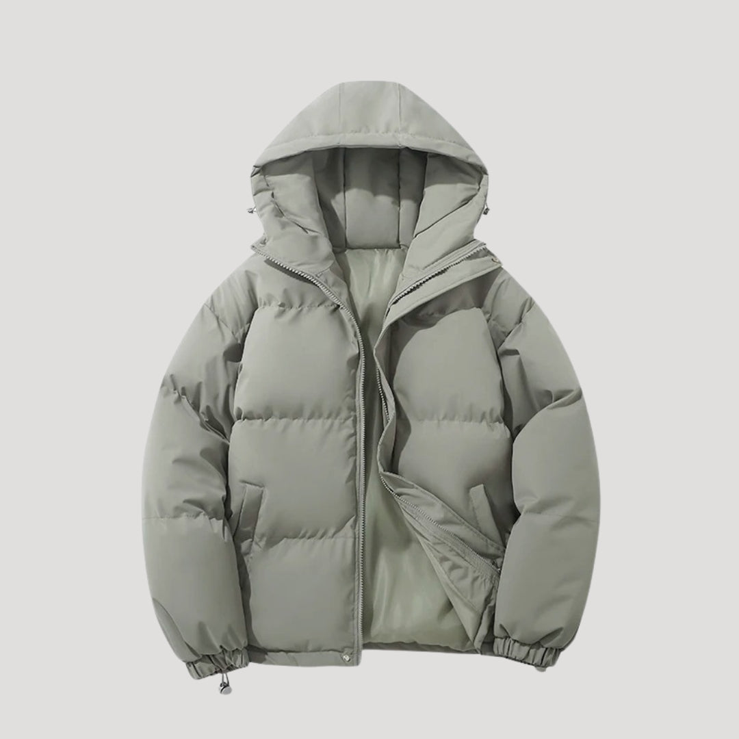 Green Evelyn hooded puffer jacket for women by Christine Brewer, insulated with a cozy hood and quilted design.