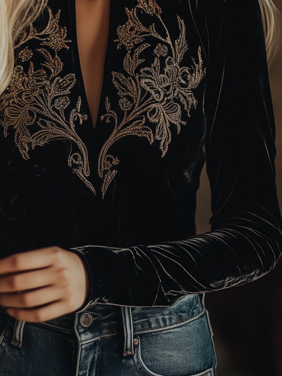 Black velvet V-neck long sleeve top with embroidered details by Christine Brewer, shown on a white background.