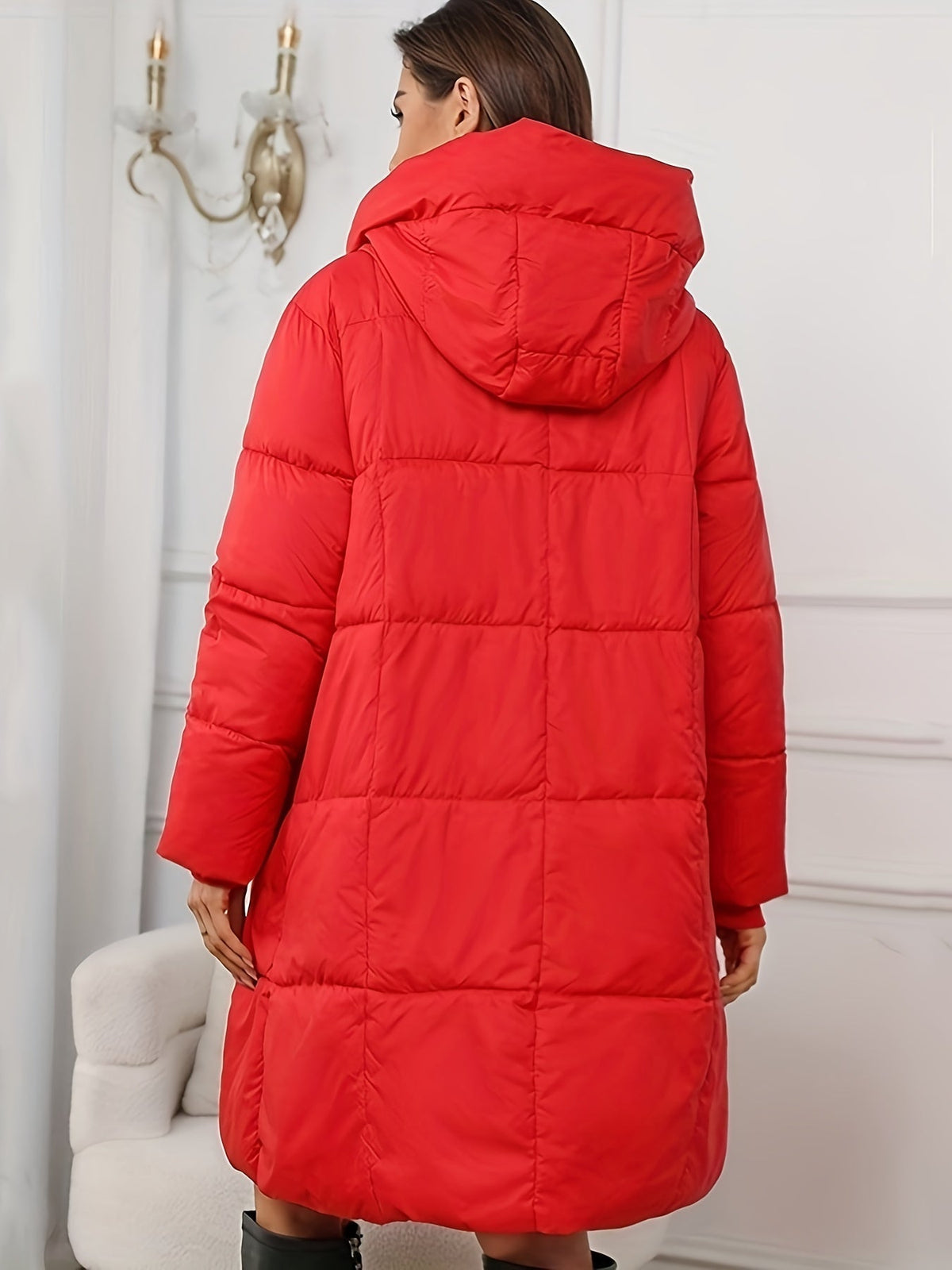 Mid-length hooded puffer jacket for women by Christine Brewer, featuring a quilted design and a cozy hood for cold weather.