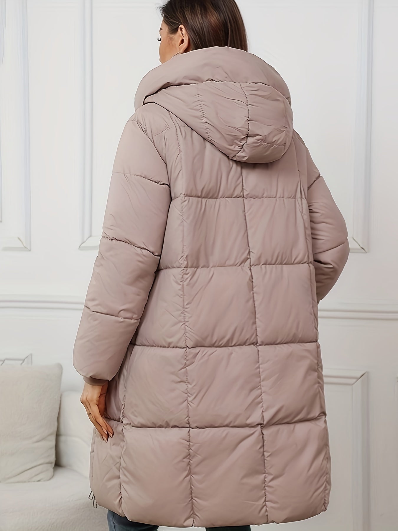 Mid-length black hooded puffer jacket for women by Christine Brewer, featuring a cozy hood and quilted design for warmth and style.