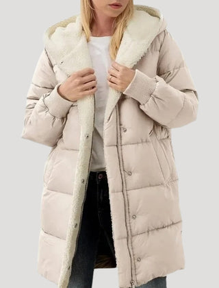 Beige Olivia hooded puffer jacket for women by Christine Brewer, featuring a faux fur-lined hood and quilted design.