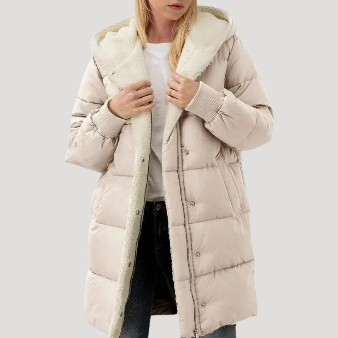 Beige Olivia hooded puffer jacket for women by Christine Brewer, featuring a faux fur-lined hood and quilted design.
