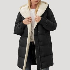 Black Olivia hooded puffer jacket for women by Christine Brewer, featuring a faux fur-lined hood and quilted design.