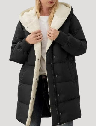 Black Olivia hooded puffer jacket for women by Christine Brewer, featuring a faux fur-lined hood and quilted design.