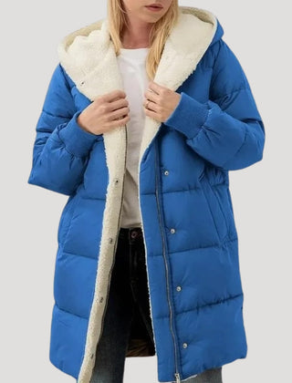Olivia women's hooded puffer jacket by Christine Brewer in blue with faux fur trim on the hood.