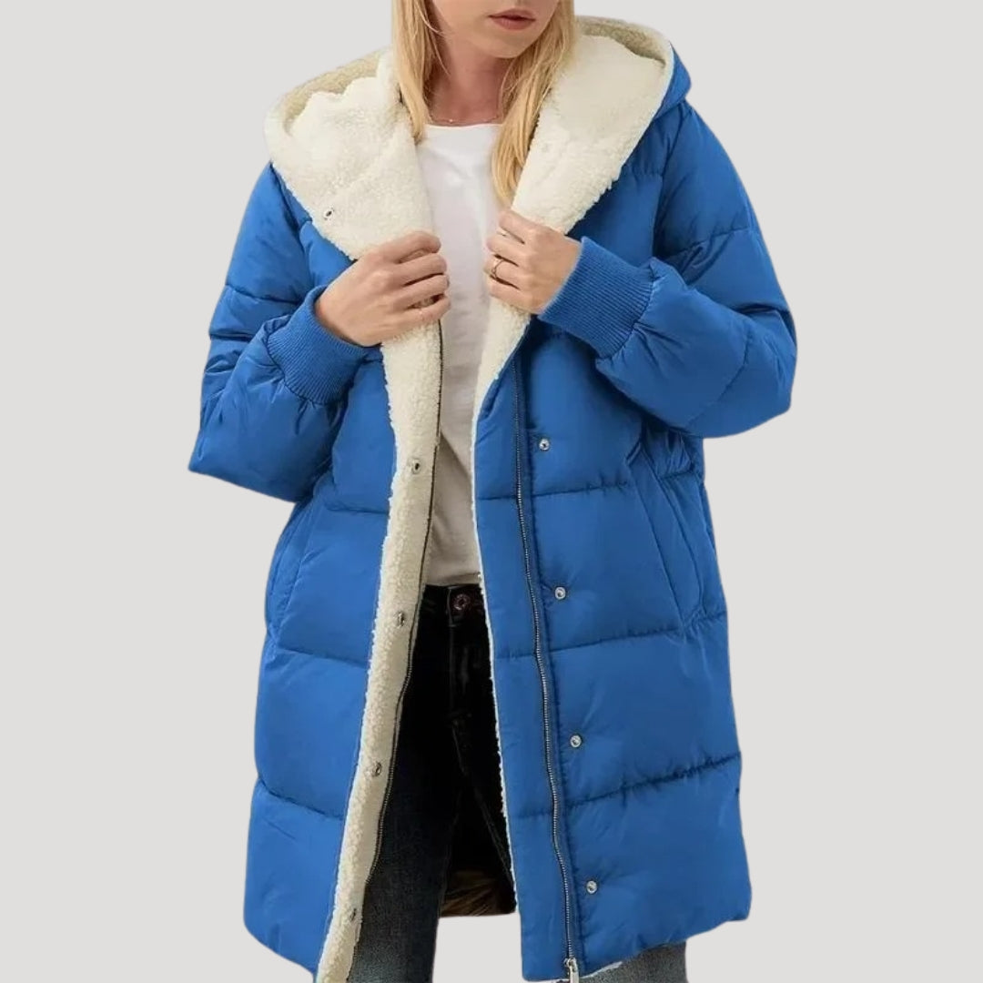 Olivia women's hooded puffer jacket by Christine Brewer in blue with faux fur trim on the hood.