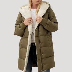 Green Olivia hooded puffer jacket for women by Christine Brewer, featuring a faux fur-lined hood and quilted design.