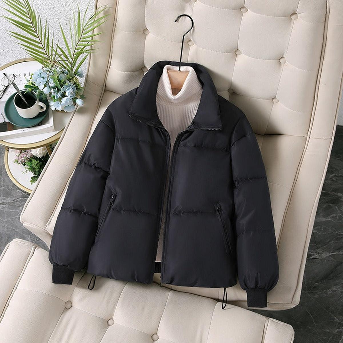 Black quilted puffer jacket for women by Christine Brewer, featuring a stylish, padded design perfect for cold weather.