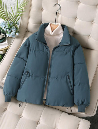 Blue Ava quilted puffer jacket for women by Christine Brewer, showcasing its stylish quilted design and cozy fit.