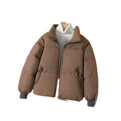 Brown quilted puffer jacket for women by Christine Brewer, featuring a stylish, insulated design perfect for cold weather.