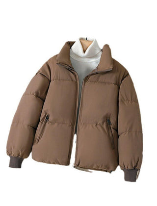 Brown quilted puffer jacket for women by Christine Brewer, featuring a stylish, insulated design perfect for cold weather.