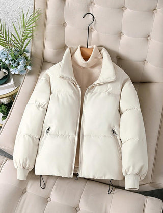 White Ava quilted puffer jacket for women by Christine Brewer, shown on a model, featuring a stylish, insulated winter jacket design.