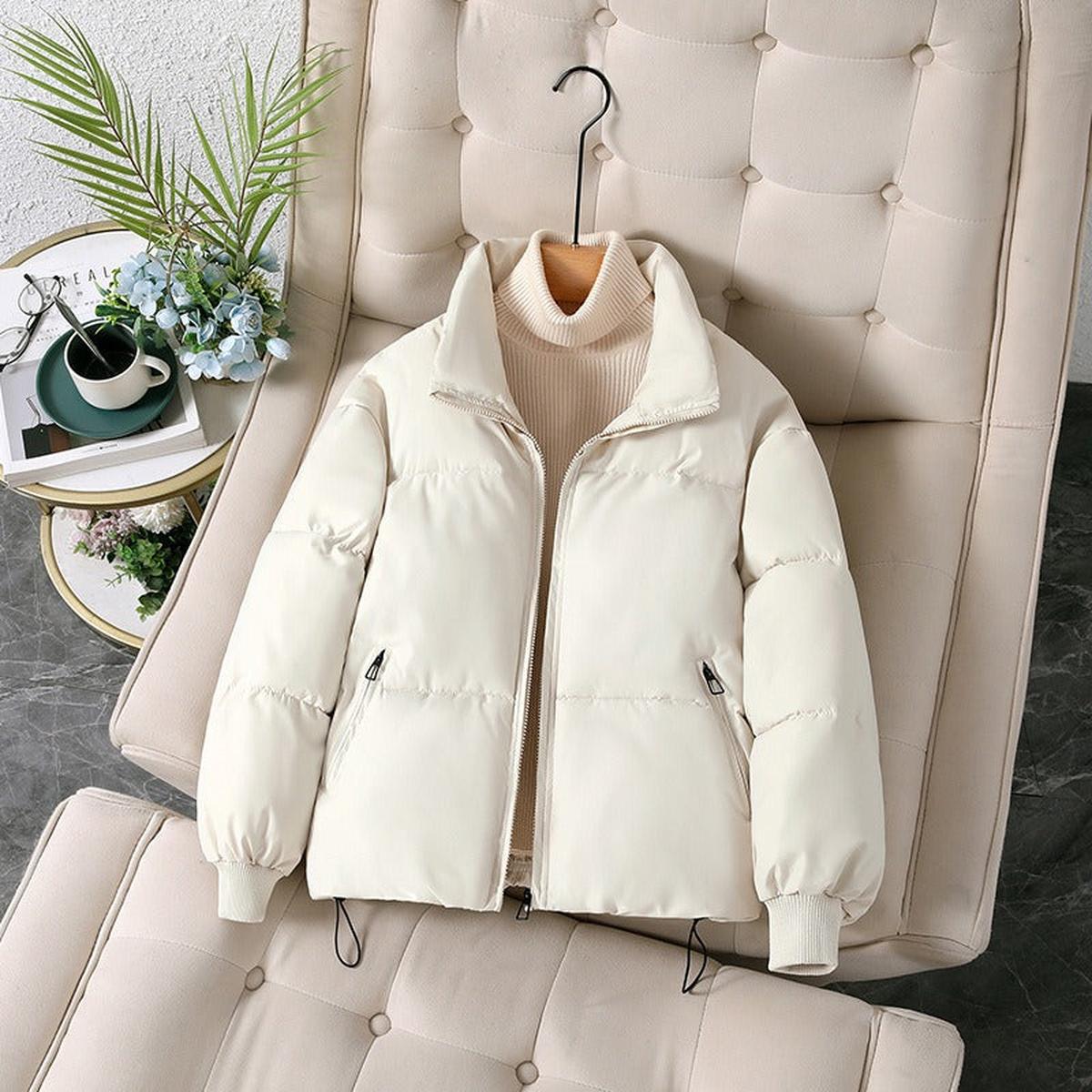 White Ava quilted puffer jacket for women by Christine Brewer, shown on a model, featuring a stylish, insulated winter jacket design.
