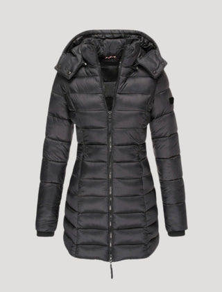 Black Isabella long puffer jacket for women by Christine Brewer, shown on a model, highlighting its padded, warm design.