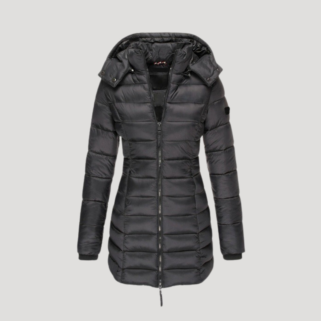 Black Isabella long puffer jacket for women by Christine Brewer, shown on a model, highlighting its padded, warm design.