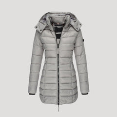 Gray Isabella long puffer jacket for women by Christine Brewer, showing a stylish, insulated winter coat with a high collar.