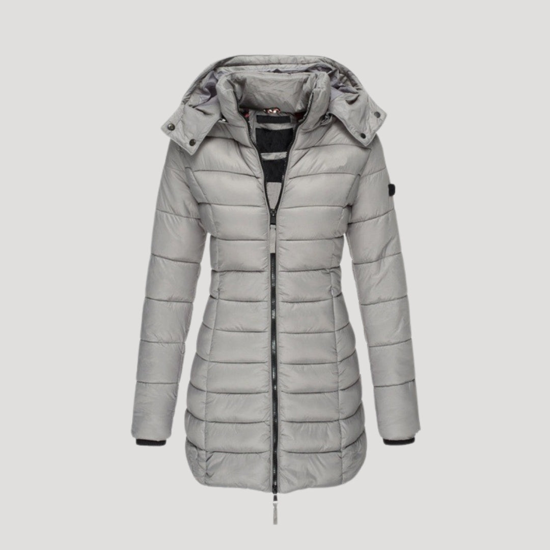 Gray Isabella long puffer jacket for women by Christine Brewer, showing a stylish, insulated winter coat with a high collar.